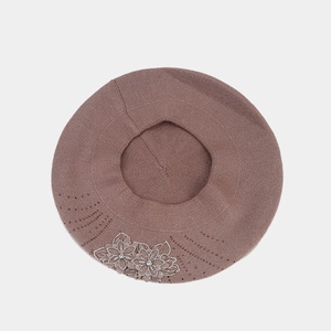 Brown knitted beret hat for women with embroidered flowers and rhinestones on white background