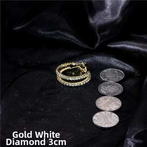 Detailed close-up of 3cm gold crystal hoop earrings showing size on black silk fabric