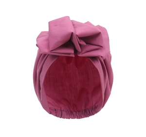Detail of soft purple cotton turban hat for babies featuring a large decorative bow