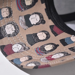 Detailed close-up of cartoon character prints and fine stitching on high-density canvas brim