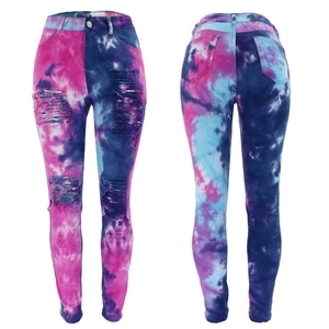 Detail of pink and blue tie-dye skinny jeans with distressed ripped knees and whiskers