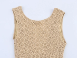 Close-up of khaki hollow lace knit dress showing intricate wavy texture and round neckline