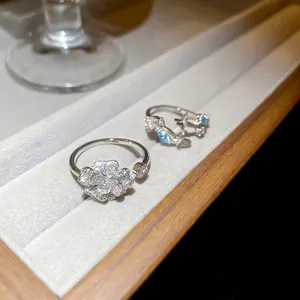 Elegant silver camellia flower ring with white zircon stones and adjustable open band