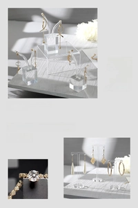 Close-up of clear acrylic earring stands and ring display in a minimalist jewelry setup