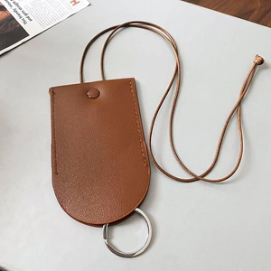 Close-up of brown faux leather magnetic glasses holder necklace with metal keychain