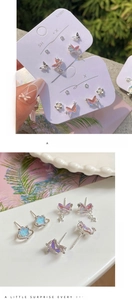 Detailed view of silver butterfly and planet studs with iridescent resin on S925 pins