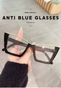 Close-up of retro black and gold cat-eye glasses with anti-blue light protective lenses