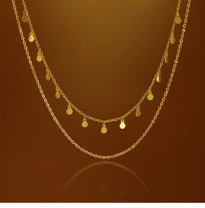 Close-up of double-layered 18K gold-plated necklace featuring small circular disk pendants