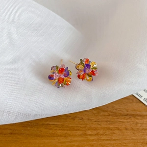Detailed close-up of colorful cluster stud earrings featuring vibrant faceted crystals