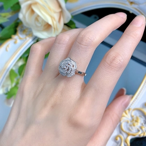 Detailed view of an S925 silver camellia ring featuring micro-pave diamond petals on a model