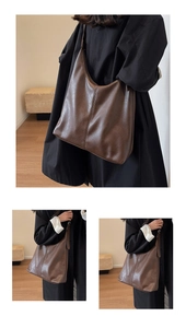 Macro detail of the smooth texture and rich brown leather of the large hobo tote bag