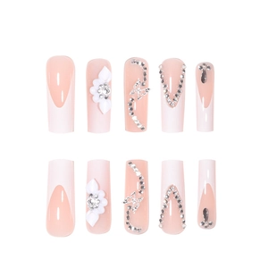 Long coffin fake nails with pink base, white French tips, 3D floral accents and crystal chains