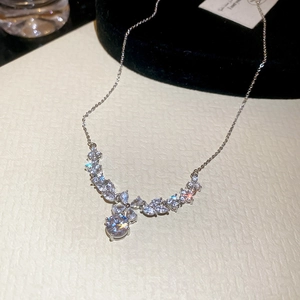 Close-up of zircon flower pendant necklace with shimmering silver tone metal finish