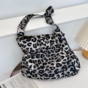 Detail of stylish leopard print canvas tote bag with wide straps for daily shoulder use