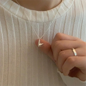 Minimalist 925 sterling silver V-shape pendant necklace and smooth ring on knit sweater