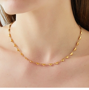 Detailed view of an 18K gold plated necklace featuring delicate heart-shaped metal links