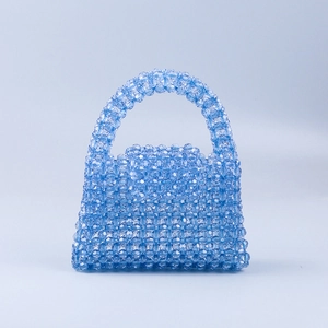 Detail of light blue handmade beaded handbag with transparent faceted acrylic beads