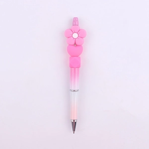 Close-up of pink gradient DIY beaded pen with silicone flower and heart toppers