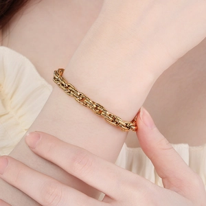 Modern gold titanium steel thick twist chain bracelet shown on a person's wrist