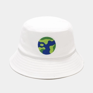 Close-up of earth embroidery and reinforced stitching on white cotton bucket hat