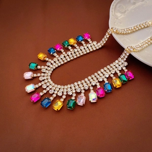 Macro shot of colorful rectangular crystals and rhinestone chain on a vintage plate