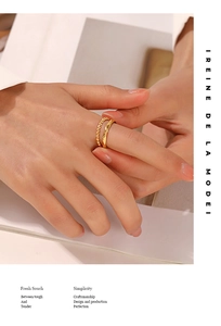 Detail of a double-layered gold titanium steel ring with beaded and twisted textures