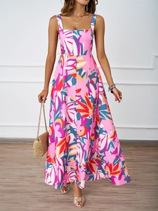 Detail shot of pink floral summer maxi dress featuring vibrant tropical patterns