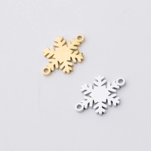 Detailed view of 15.5x12mm snowflake jewelry charms in gold and silver mirror finish
