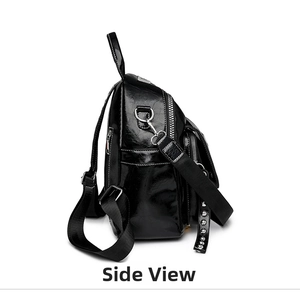 Side view of black rhinestone backpack featuring shiny leather and silver metal studs