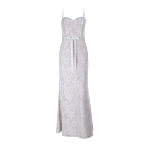 Detailed view of floral lace pattern and silk bow on white bustier maxi dress