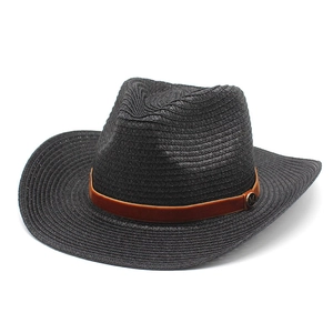 Detail of black straw cowboy hat featuring brown suede band and metal M logo plaque