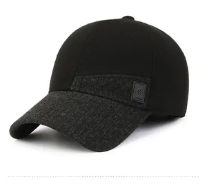 Detail view of winter baseball cap with black knit body and grey textured visor side logo