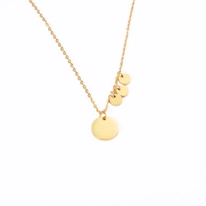 Macro detail of golden stainless steel necklace featuring four polished round disc charms