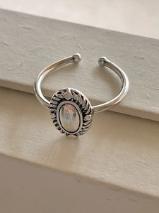 Macro shot of 925 sterling silver oval ring with vintage texture and polished finish
