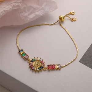 Macro view of 18K gold adjustable bracelet with colorful zircons and Virgin Mary charm
