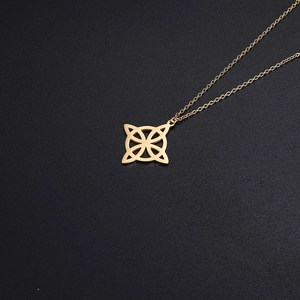 Detailed view of a golden Celtic knot pendant necklace with a polished cutout design