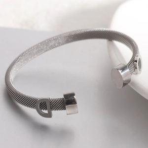 Detail of 6mm silver stainless steel cable mesh cuff bracelet with hollow letter D charm