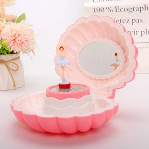 Detail of pink shell music box with rotating ballerina doll and oval mirror inside