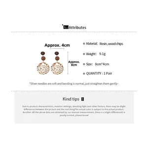 Detail of resin leopard print hoop and wood beads on silver needle statement earrings