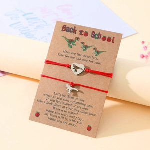 Detail showing two red dinosaur bracelets on Back to School gift card for mother and daughter
