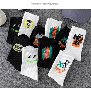 Flat lay of cotton crew socks with colorful street graffiti prints and urban style patterns