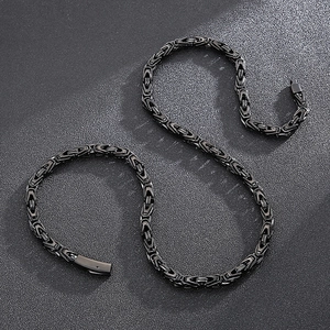 Close-up of black woven stainless steel emperor chain with detailed link texture