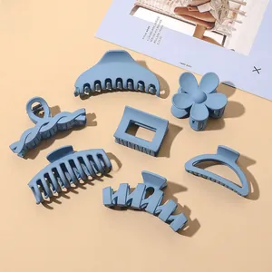 Detailed set of 7 matte blue shark hair clips in assorted minimalist shapes