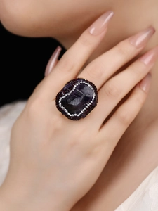 Detailed close-up of a vintage cocktail ring with raw amethyst and pavé zircons
