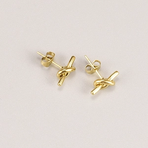 Detailed view of 18K gold plated titanium steel knot earrings with polished finish