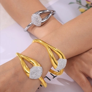 Chic gold and silver open bangles featuring hollow teardrop designs with pavé diamonds