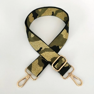 Close-up of camouflage wide strap with golden threads and pale gold metal lobster clasps