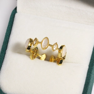 Close-up of golden marquise opal and zircon ring in an emerald velvet jewelry box