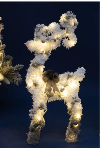 Detail of a white flocked reindeer with warm LED lights, pine cones and a burlap bow