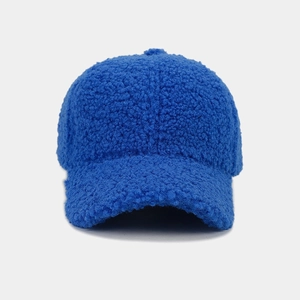 Detailed texture of thick blue teddy fleece fabric on a winter baseball cap brim